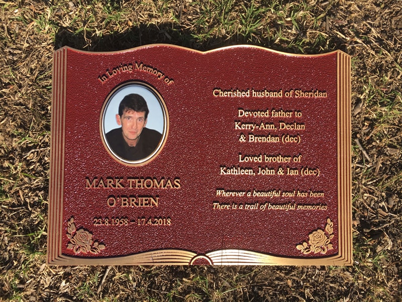 Memorial plaque with portrait in cemetery garden