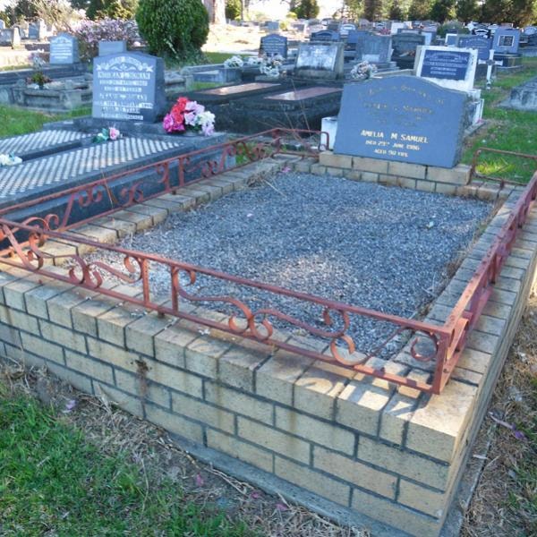 Amelia M Samuel grave before restoration — brick surround with rusty iron railing