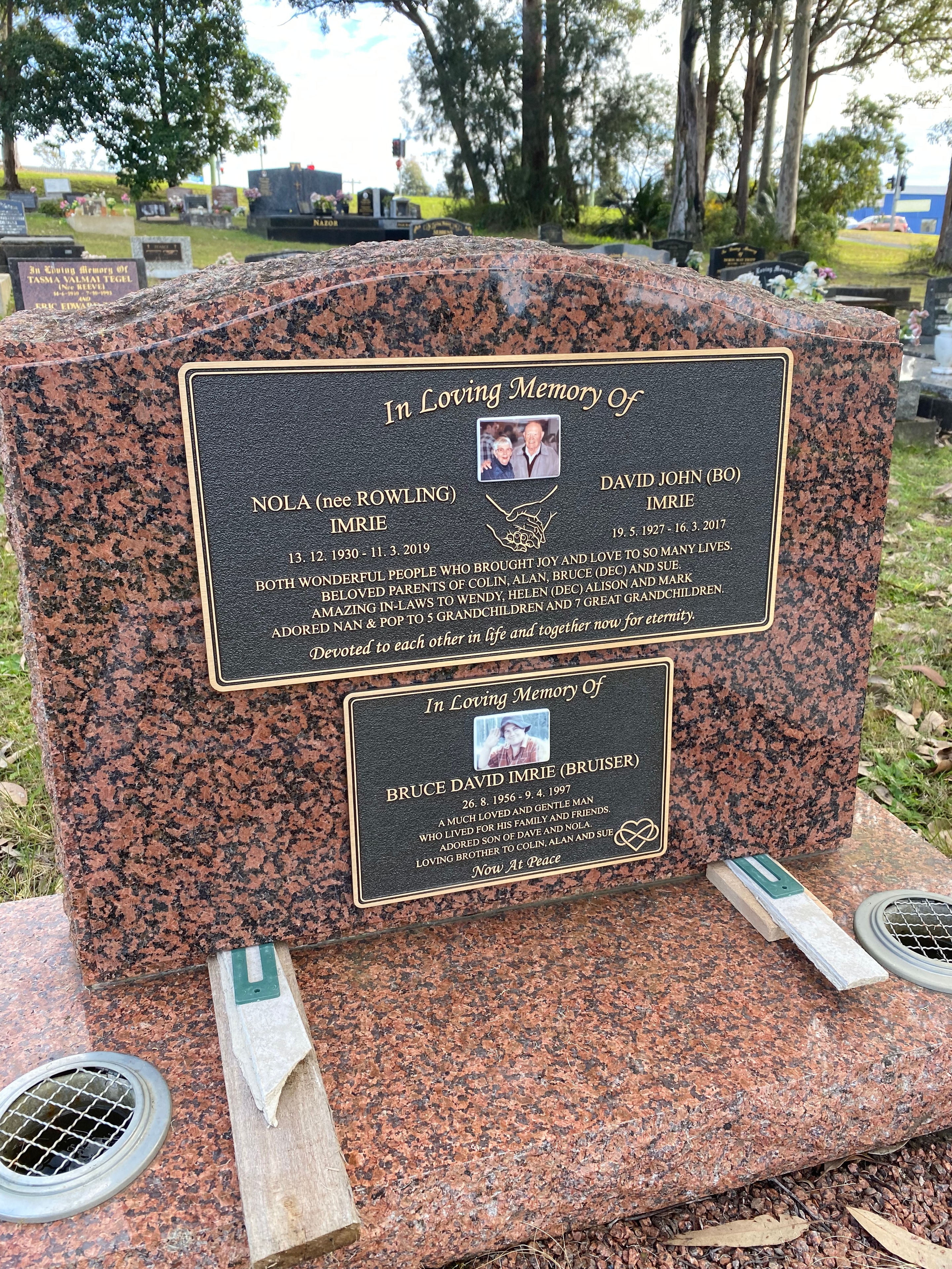 Imrie family bronze memorial plaques on rose granite monument