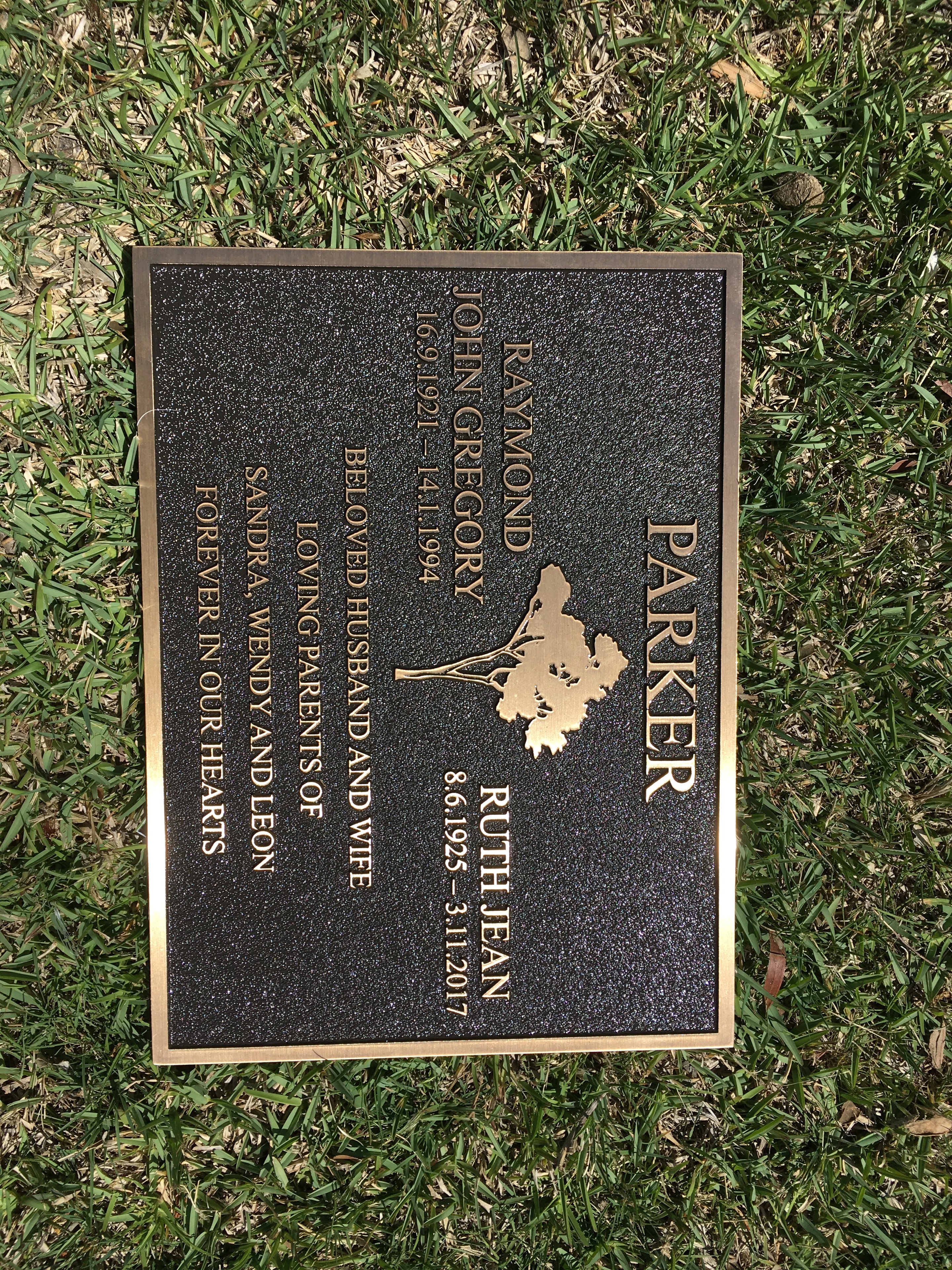 Raymond John Gregory Parker and Ruth Jean Parker bronze memorial plaque on grass