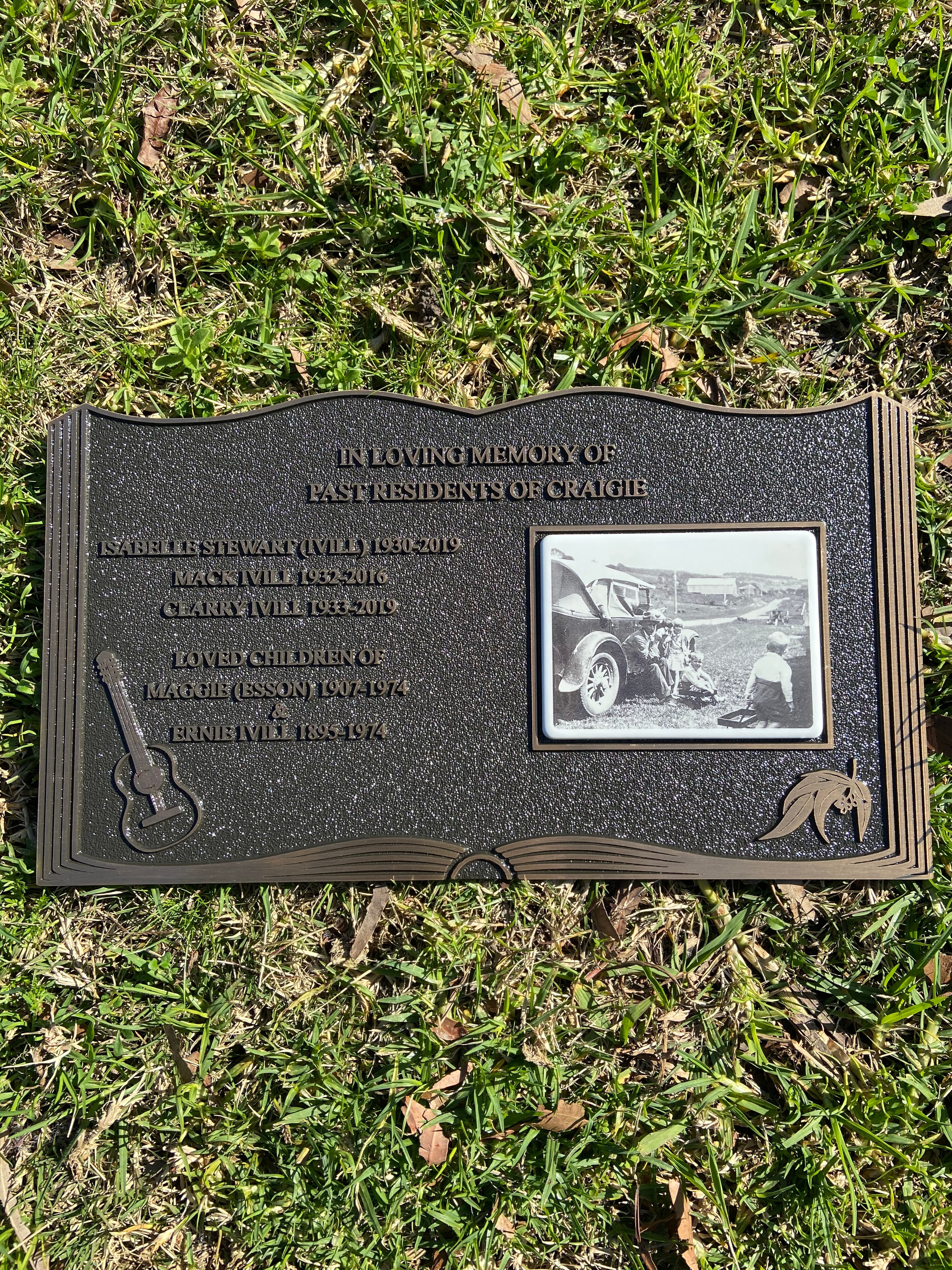Past residents of Craigie bronze memorial plaque with historical photograph and musical motif