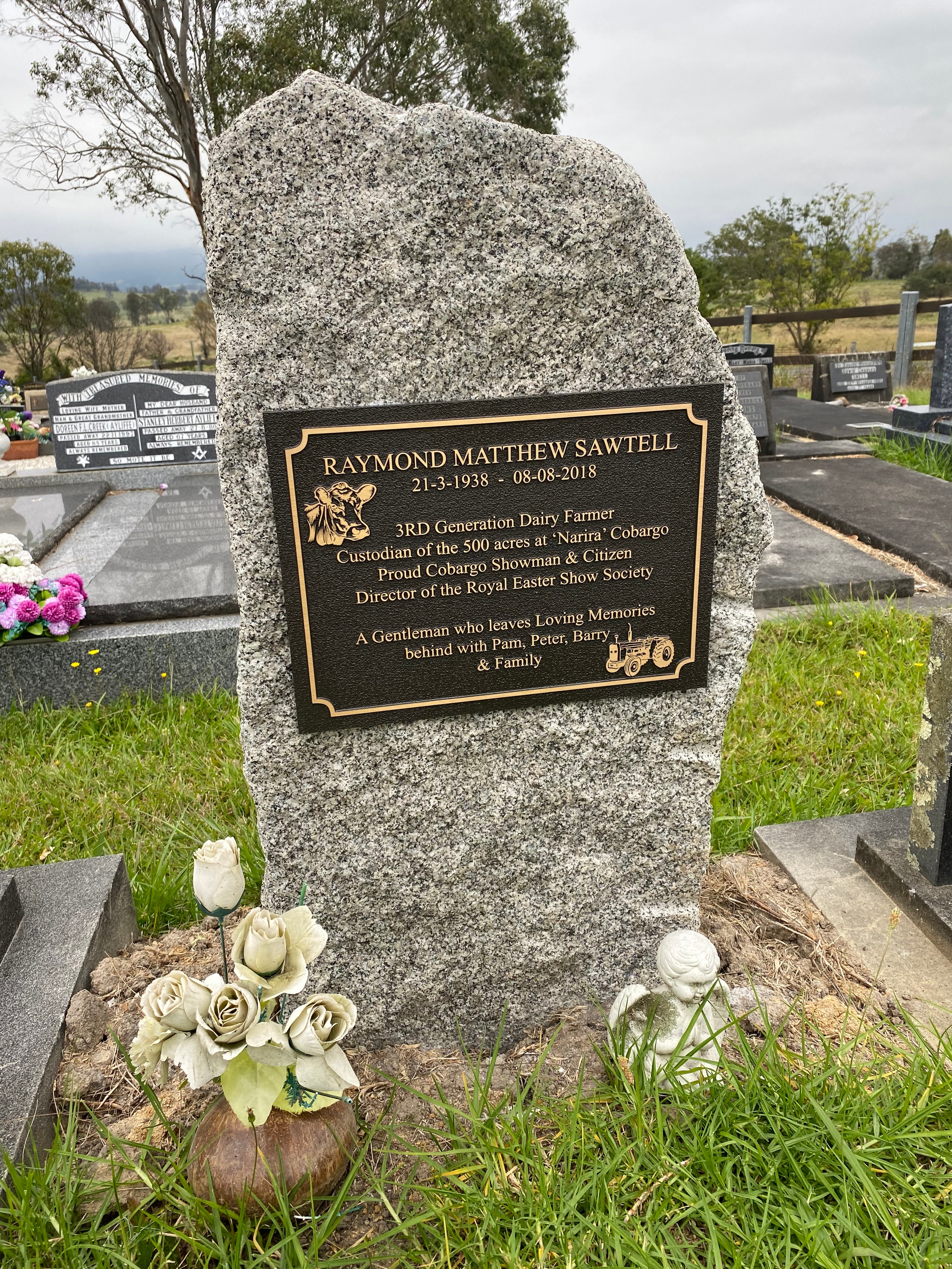 Raymond Matthew Sawtell bronze memorial plaque on granite monument
